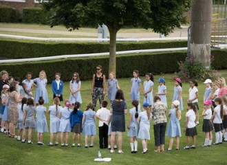 A group of children in a circle singing