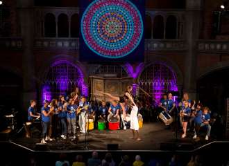 Youth singing together with a dancer in the middle